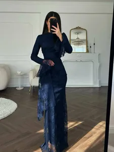 Elegant navy blue lace long sleeve evening gown featuring sophisticated ruffle detail