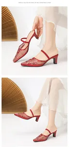 Elegant close-up of red rhinestone pointed-toe mule heels with hollow mesh design