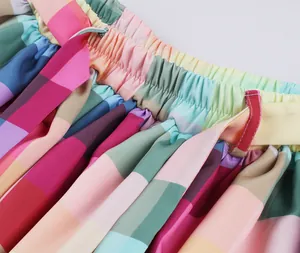Detailed macro view of elastic waistband on vibrant rainbow checkered pleated skirt