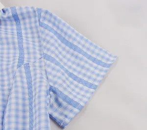 Detail shot of vintage blue and white plaid short sleeve with delicate lace inserts.