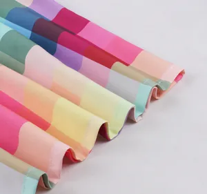 Close-up showing the colorful rainbow plaid pattern and hemline of the retro skirt