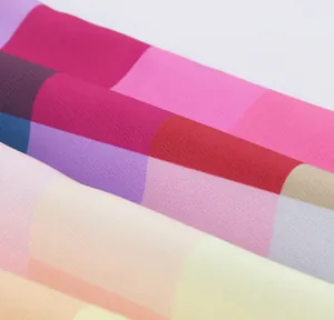 Macro view showing the vibrant texture of the rainbow checkered fabric detail.