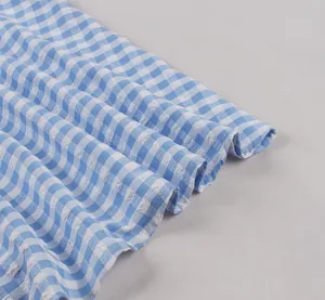 Detailed macro view of blue and white gingham textured fabric with elegant ruffle pleats