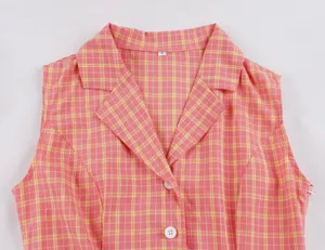 Primer plano de vestido a cuadros rosa estilo Hepburn con cuello sastre