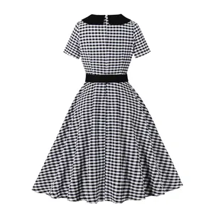 Vintage black and white gingham dress with contrast collar and flared skirt detail.