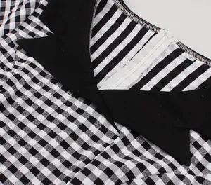 Close-up of retro black and white checkered dress with back zipper and contrast collar