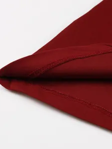Detailed view of the hemline and stitching on a vintage wine red cotton midi dress