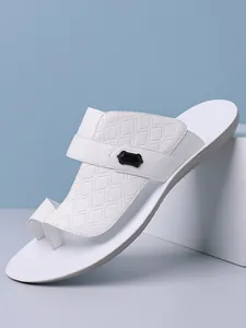 Detailed view of white men's Arabic style sandals with textured patterns and soft sole