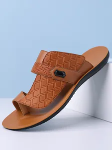 Detailed side view of premium brown textured men's slide sandal with comfortable toe ring
