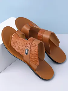 Close-up detail of brown leather men's sandals featuring embossed diamond patterns