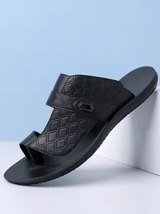 Side view of black men's Arabic sandal showing embossed diamond pattern and buckle detail.