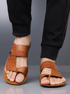 Detailed view of men's brown textured leather sandals with non-slip soft sole