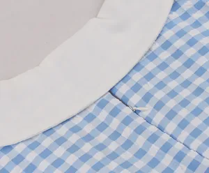 Close-up detail of blue and white gingham dress showing fabric texture and invisible zipper