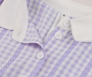 Close-up of retro purple plaid dress showing white shirt collar and button details