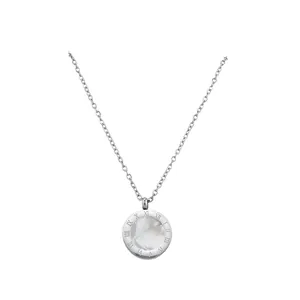 Close-up detail of silver necklace featuring a round pendant with Roman numerals and white inlay.