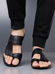 Close-up of men's black textured leather sandals with soft non-slip soles for outdoor use
