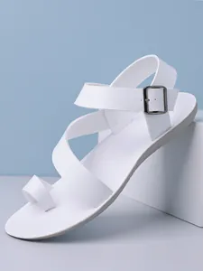 Detail view of white minimalist men's sandals with toe loop and adjustable metal buckle strap
