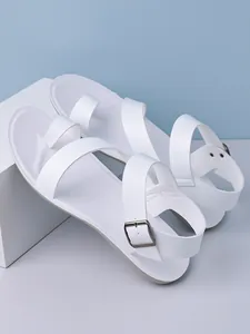 Detailed side view of white men's sandals with toe loop and adjustable buckle strap