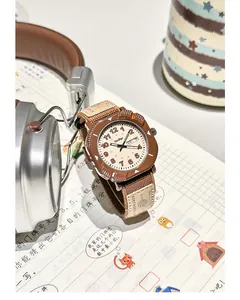 Detailed view of a retro brown canvas strap watch featuring a dual calendar on cream dial