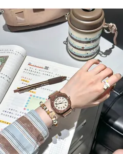 Detailed view of a brown canvas strap student watch with dual calendar display