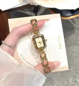 Close-up of a vintage minimalist gold quartz watch with a chain-link strap for women