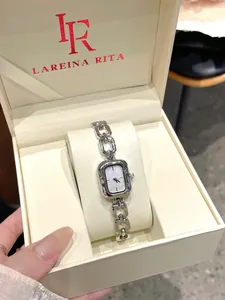 Elegant silver rectangular quartz watch with chain link strap in branded beige box.
