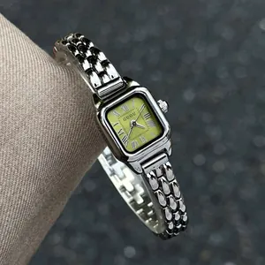 Elegant vintage lady's quartz watch with square green dial and silver metal link bracelet