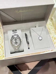 Elegant silver watch gift set featuring a ladies watch, bangle, and necklace in a pink box.