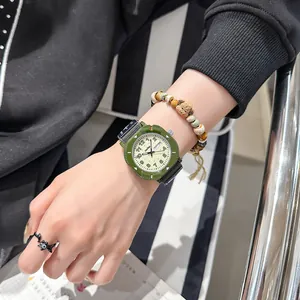 Minimalist olive green student watch with canvas strap and double calendar