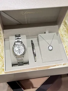 Detail view of ladies silver quartz watch, bracelet, and necklace in a premium gift box