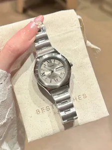 Silver ladies' quartz watch with day-date display, Roman numerals, and link bracelet