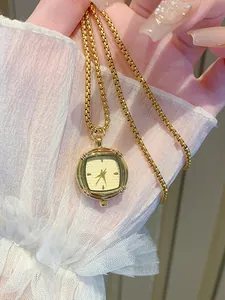 Elegant vintage square gold watch pendant necklace on a delicate gold box chain.