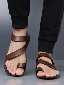 Close-up view of premium brown leather toe-loop sandals for men featuring stylish cross straps.