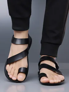 Close-up detail of men's black leather sandals featuring cross strap and toe loop design