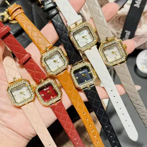 Close-up of stylish square women's watches featuring quilted straps and rhinestone bezels.