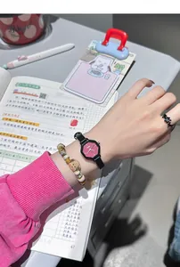 Close-up of octagonal pink quartz watch on wrist with a minimalist student style.