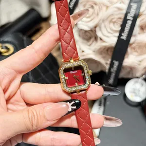 Close-up detail of Dinimi square watch featuring red quilted leather strap and crystal bezel