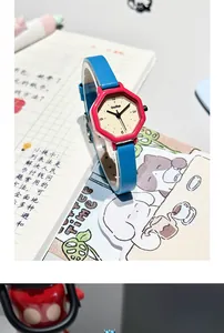 Close-up of octagonal women's quartz watch featuring pink case and vibrant blue leather strap