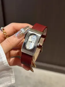 Close-up detail of GUOU luxury rectangular quartz watch featuring a red leather strap