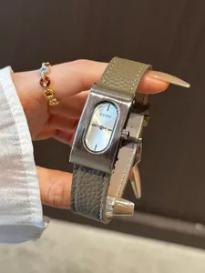 Macro view of GUOU vintage square watch with brushed metal case and leather strap