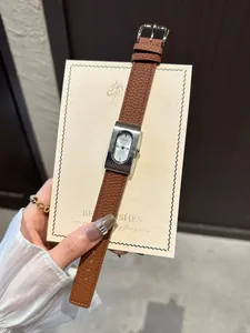 Close-up detail of GUOU vintage rectangular women's quartz watch with brown leather strap
