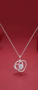 Elegant close-up of a heart-shaped 925 sterling silver pendant set with a moissanite stone