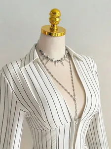 Close-up detail of a women's V-neck long sleeve shirt with black vertical stripes