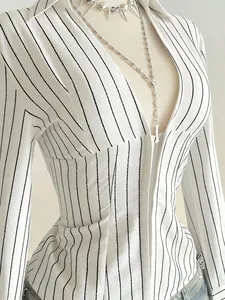 Detail shot of white slim-fit V-neck blouse with black vertical pinstripe pattern