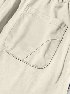 Close-up showing the pocket stitching and fabric texture of beige cotton sweatpants