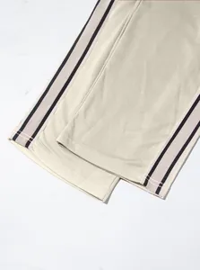 Close-up of pearl cotton twill fabric and side stripe detail on wide-leg sweatpants