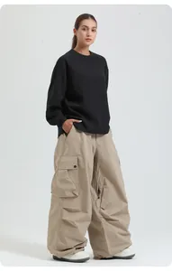 Professional waterproof tan ski pants paired with a black sweatshirt for outdoor winter sports