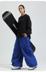 Professional loose blue waterproof cargo snowboard ski pants shown on a female model