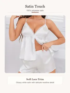 Detailed view of the soft lace trim on the white satin camisole sleepwear set for women.