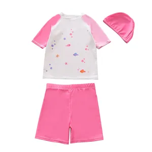 Three-piece girls swim set with pink shorts and marine life printed top and cap